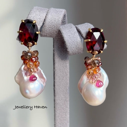 Lustrous iridescent white baroque pearls with garnet studs earrings